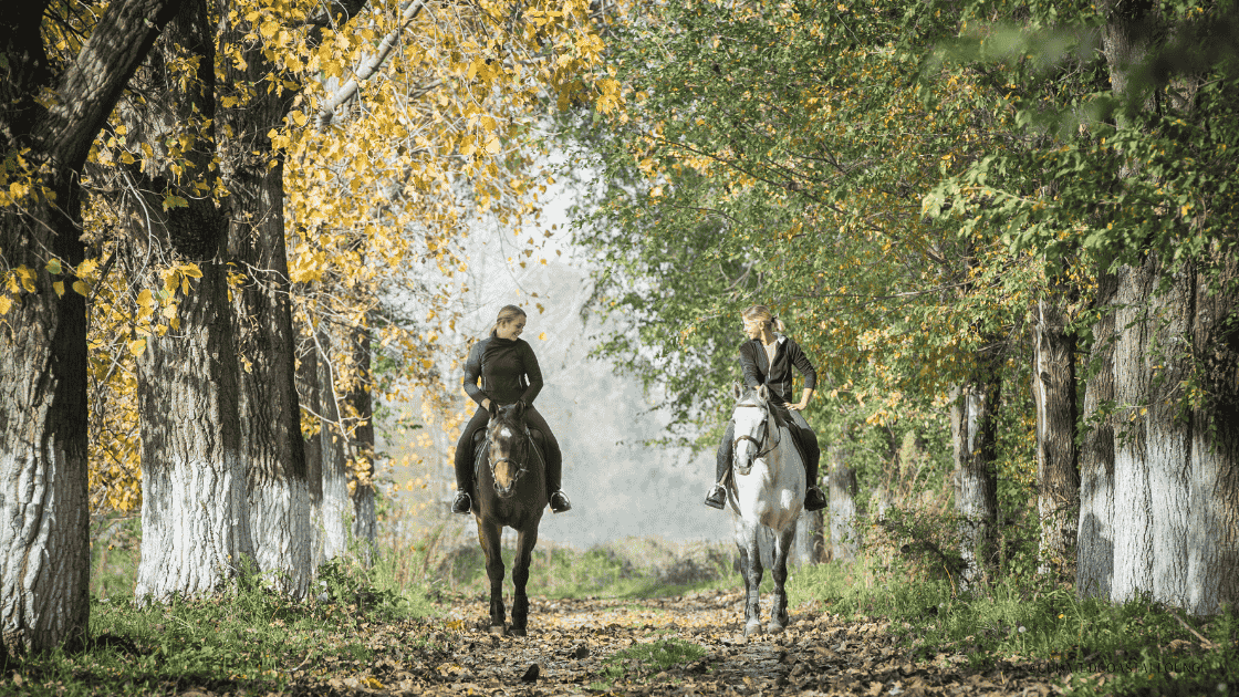 2 girls riding horses
